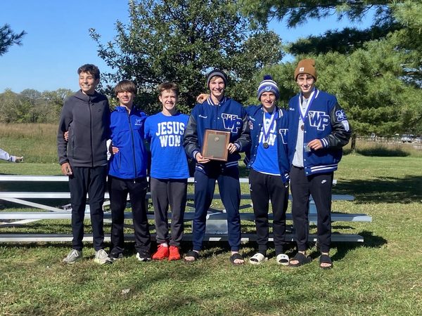 West Platte boys cross-country runners pose with the KCI Conference championship trophy after winning their third consecutive conference title Oct. 17 at Platte Ridge Park in Platte City. The three-year run marked the first such achievement in school history.