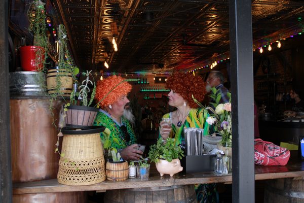 Two rompers share a conversation and a drink at a Holladay on Main during the annual Mrs. Roper Romp. Participating establishments offered food, drinks, shopping and entertainment throughout the day.