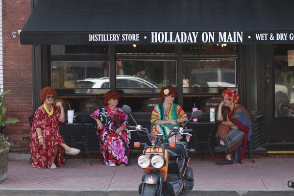Rompers take a break outside Holladay on Main during Weston’s annual Mrs. Roper Romp on Saturday, Aug. 8. The event brought costumed participants downtown for a day of shopping, dining and festivities.