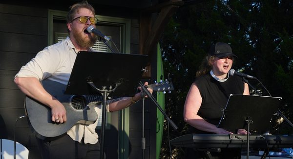 Jonah Vandel, worship leader, and Pastor Kara Wilson-Tucker sing during a worship service at the pond near Norman Landcraft Sept. 11, 2026.