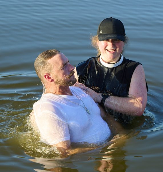 The Rev. Kara Wilson Tucker immerses William McQueen during his baptism at the pond near Norman Landcraft Sept. 11, 2026.