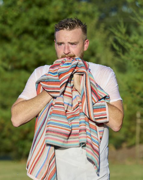 William McQueen dries his face after his baptism at the pond near Norman Landcraft Sept. 11, 2026.